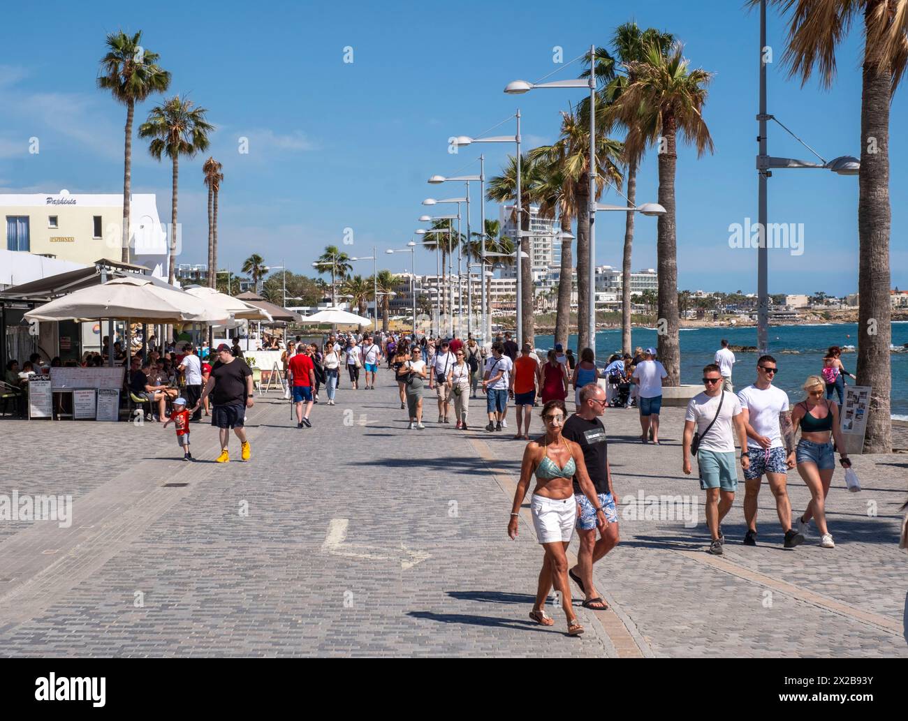 Tourists walking along the promenade at Poseidonos Avenue, Paphos, Cyprus. Stock Photo