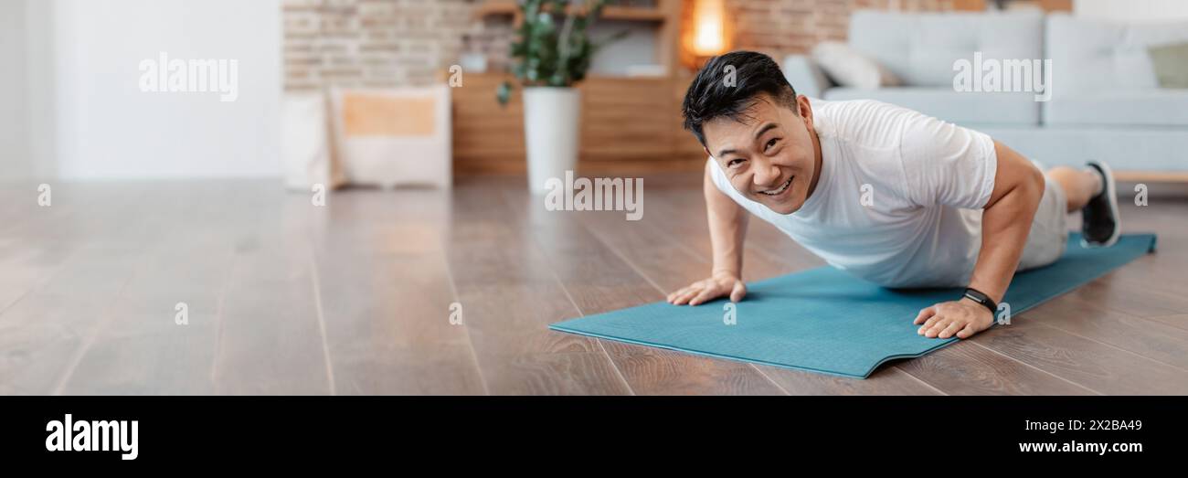 Strong asian mature man making strength workout Stock Photo