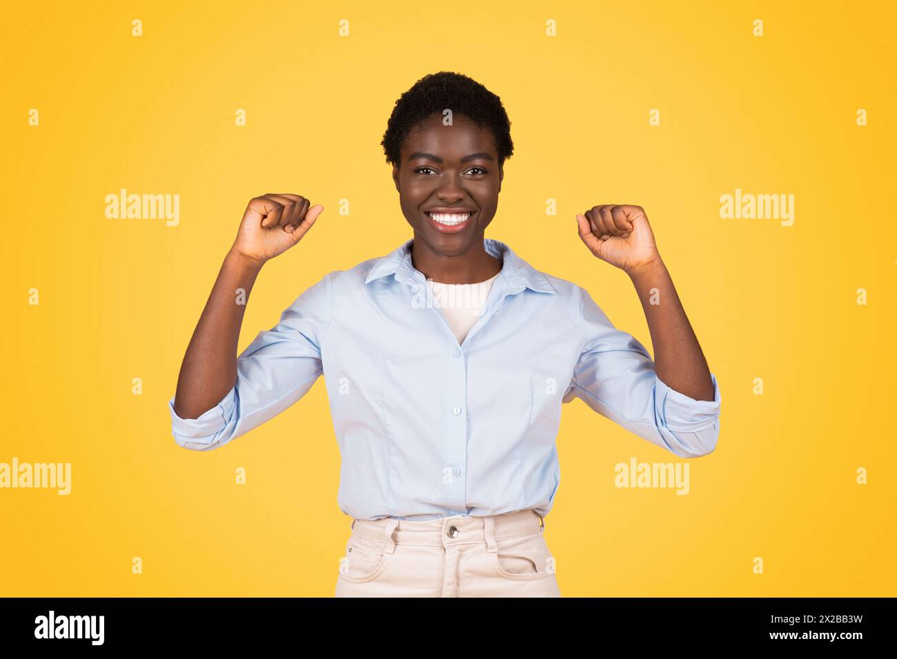 Triumphant african american woman with raised arms Stock Photo - Alamy