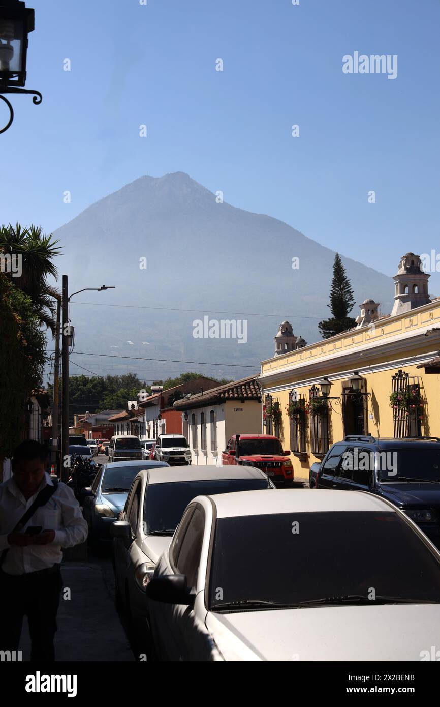 Antigua, old capital of Guatemala. Street scene, one of a series.Colourful buildings of Central America.In the background is Volcano Agua.Volcan Agua. Stock Photo