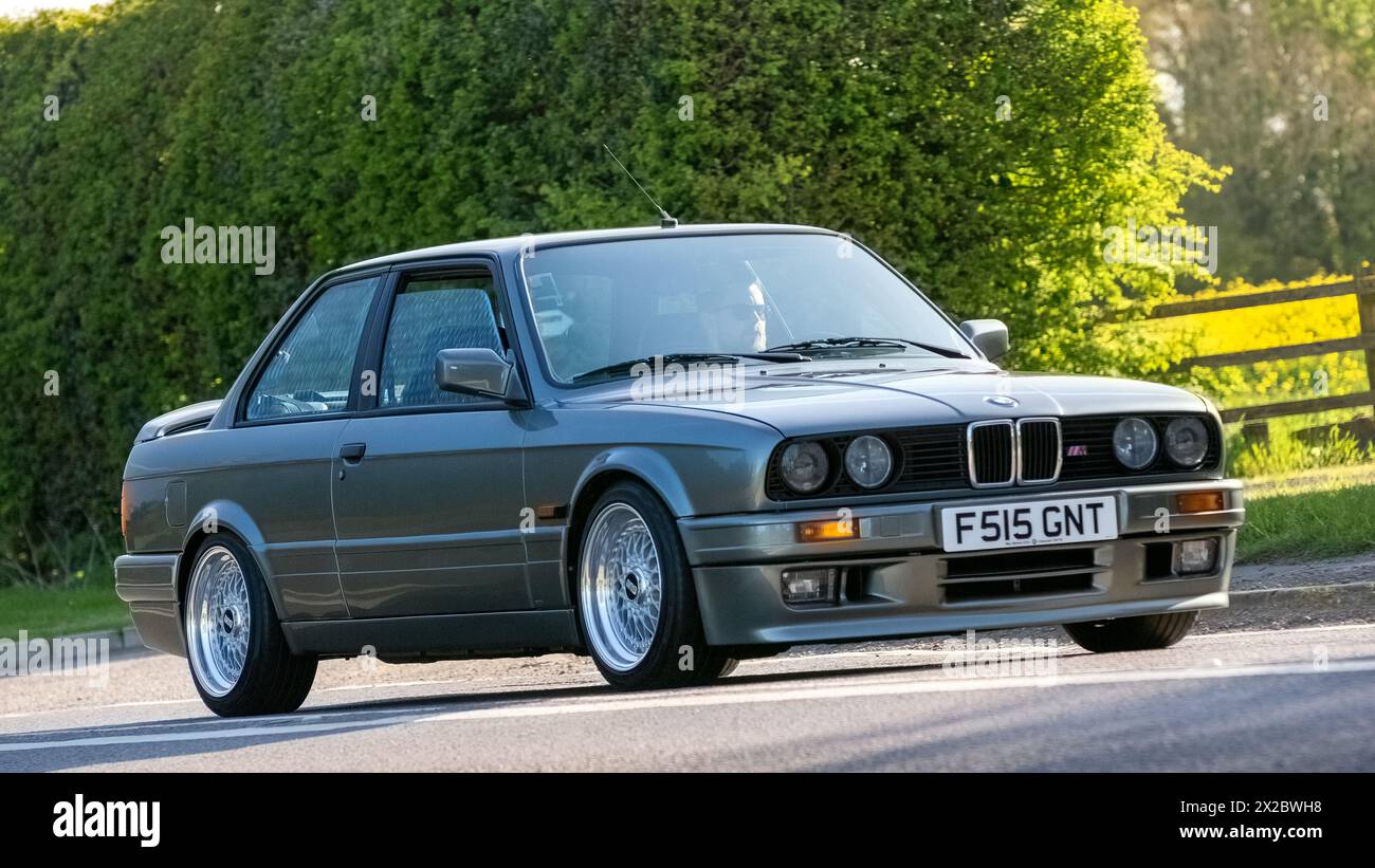 Bicester,UK- Apr 21st2024: 1988 grey BMW 3 series classic car driving on a British road Stock Photo