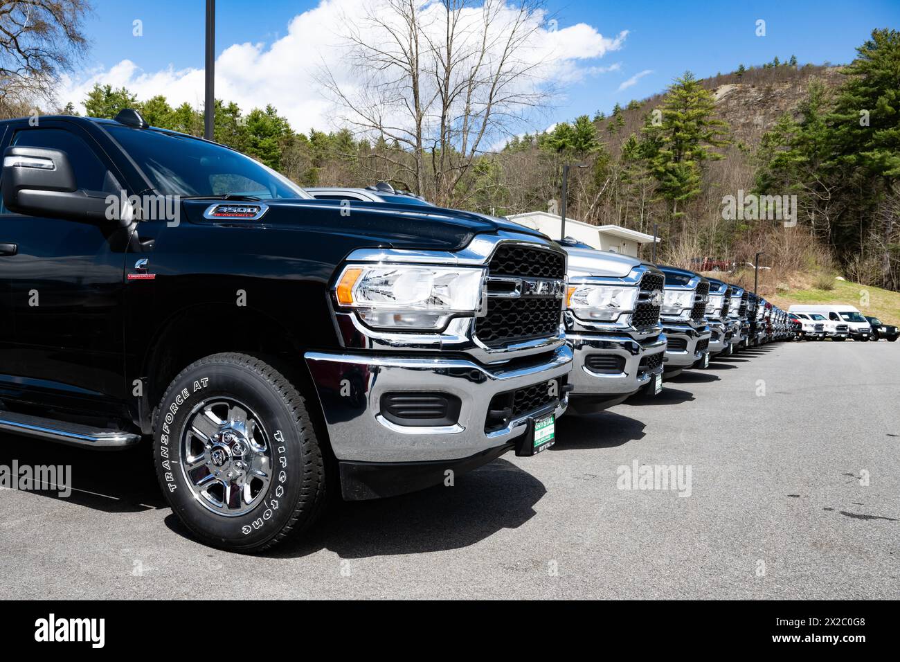 A long line of new Dodge Ram pickup trucks for sale on a dealer lot in Warrensburg, NY USA Stock Photo