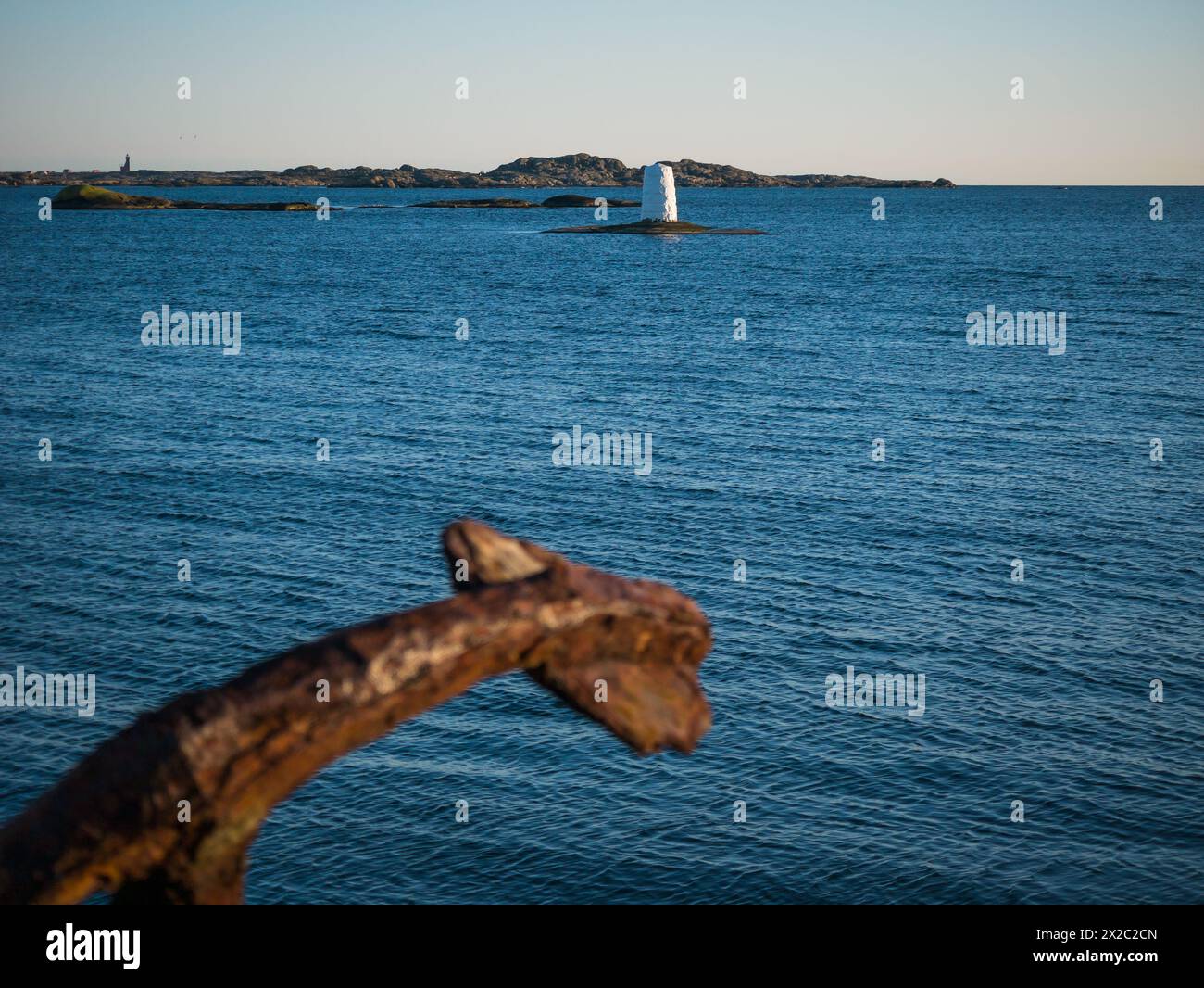 Old and rusty anchor on land overlooking the sea at Klåva, Hönö in the Gothenburg archipelago situated on the west coast of Sweden. Stock Photo