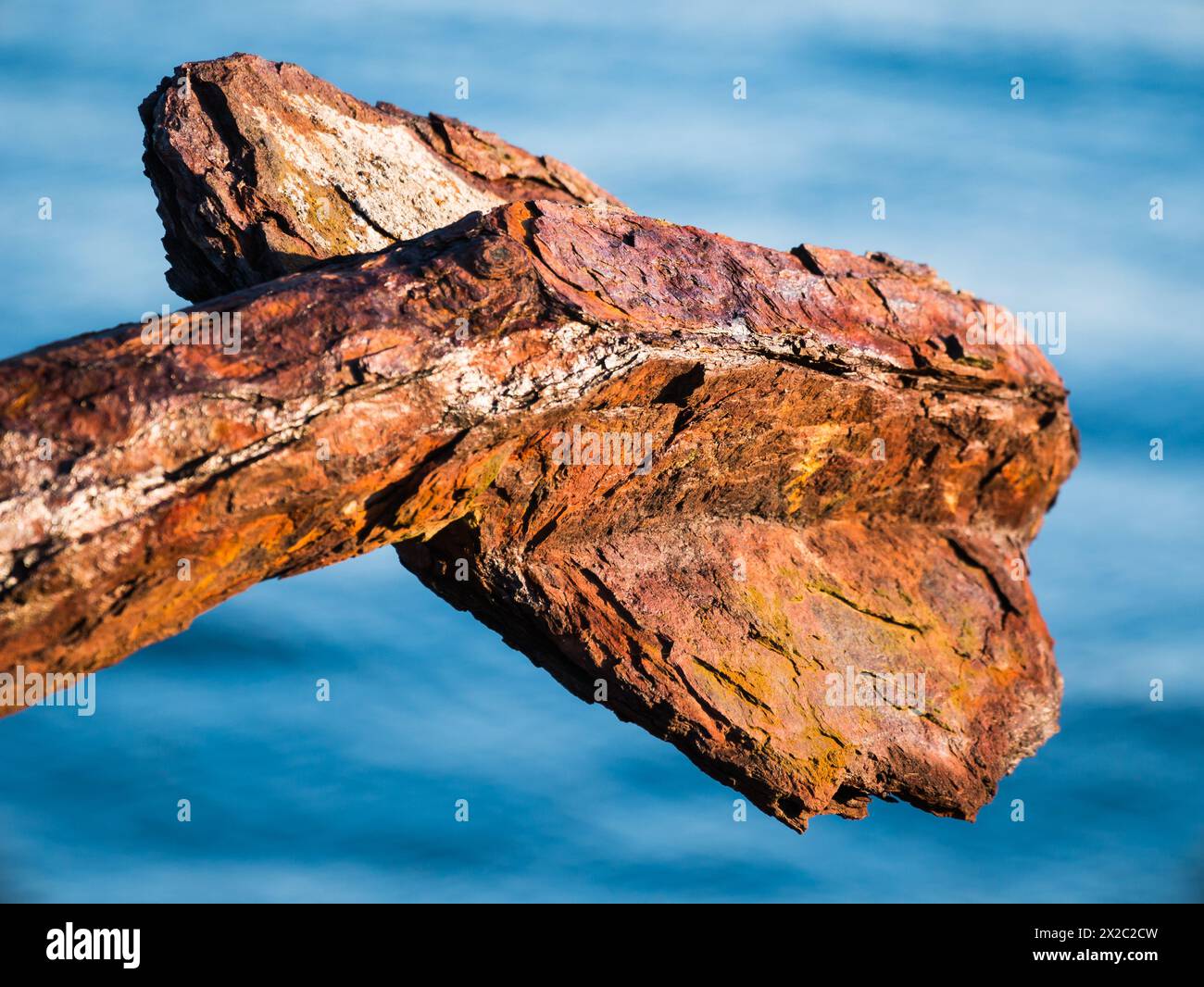Old and rusty anchor on land overlooking the sea at Klåva, Hönö in the Gothenburg archipelago situated on the west coast of Sweden. Stock Photo