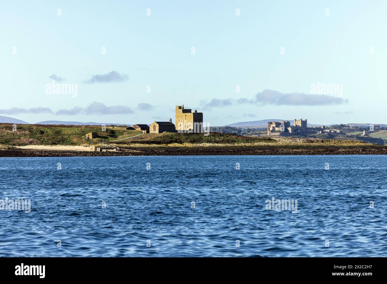 Inner Farne, one of the Farne Islands, Northumberland, with Bamburgh Castle in the distance Stock Photo