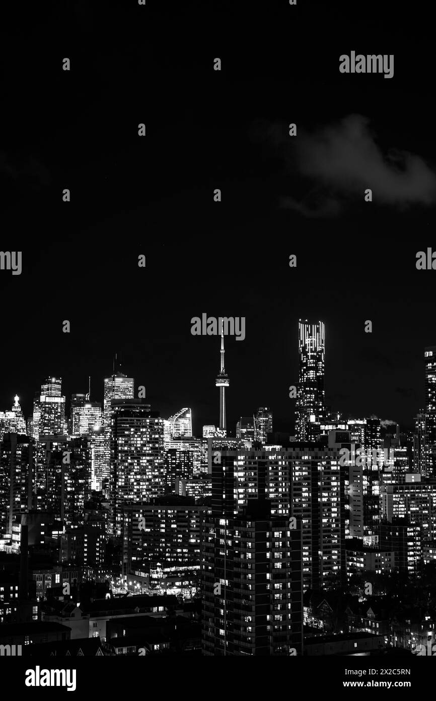 night Toronto city downtown skyline, twilight over CN Tower and skyscrapers of financial district Canada, black and white Stock Photo
