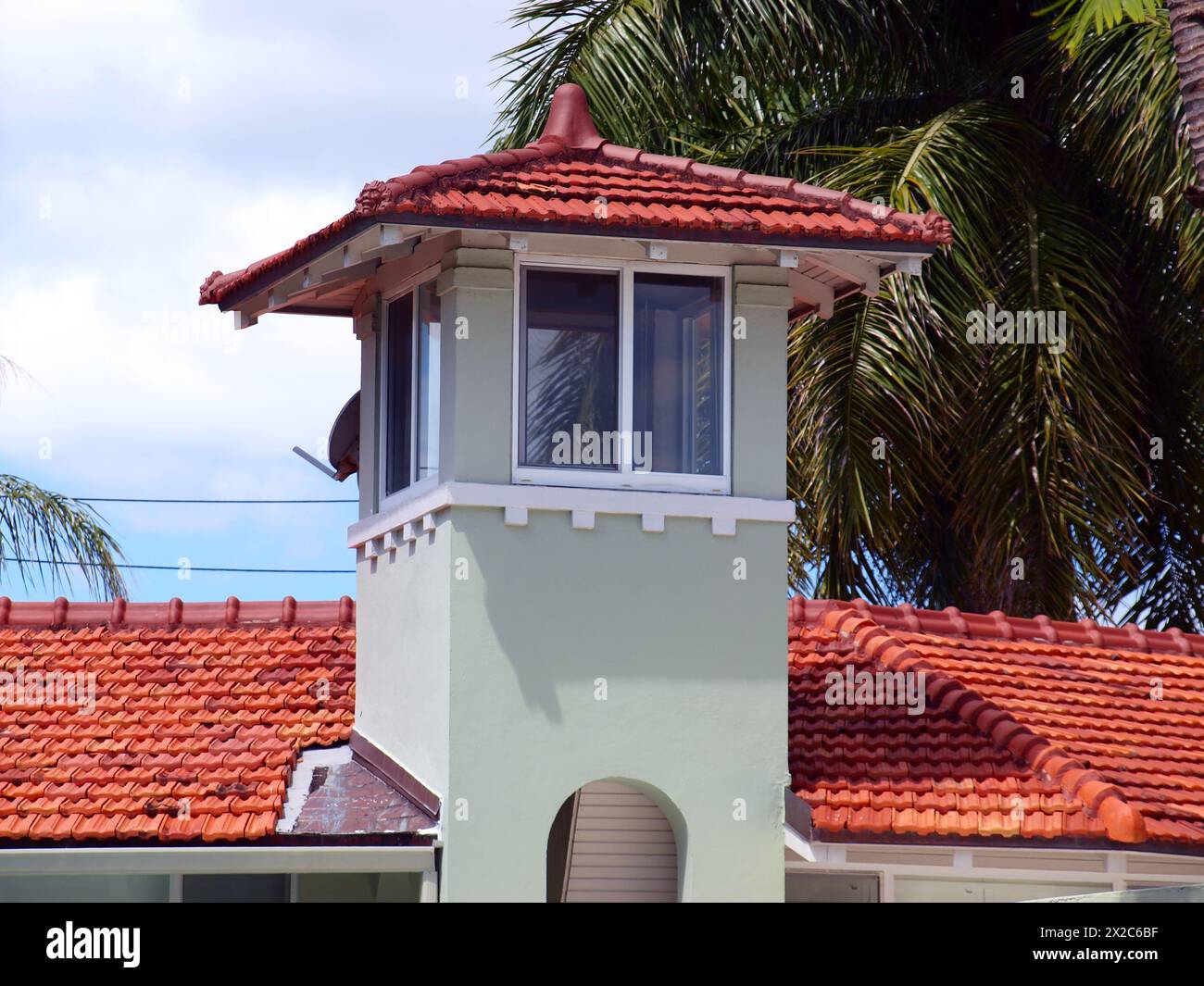 Miami, Florida, United States - April 6, 2024: Tower in a residential home with a dish antenna. Stock Photo