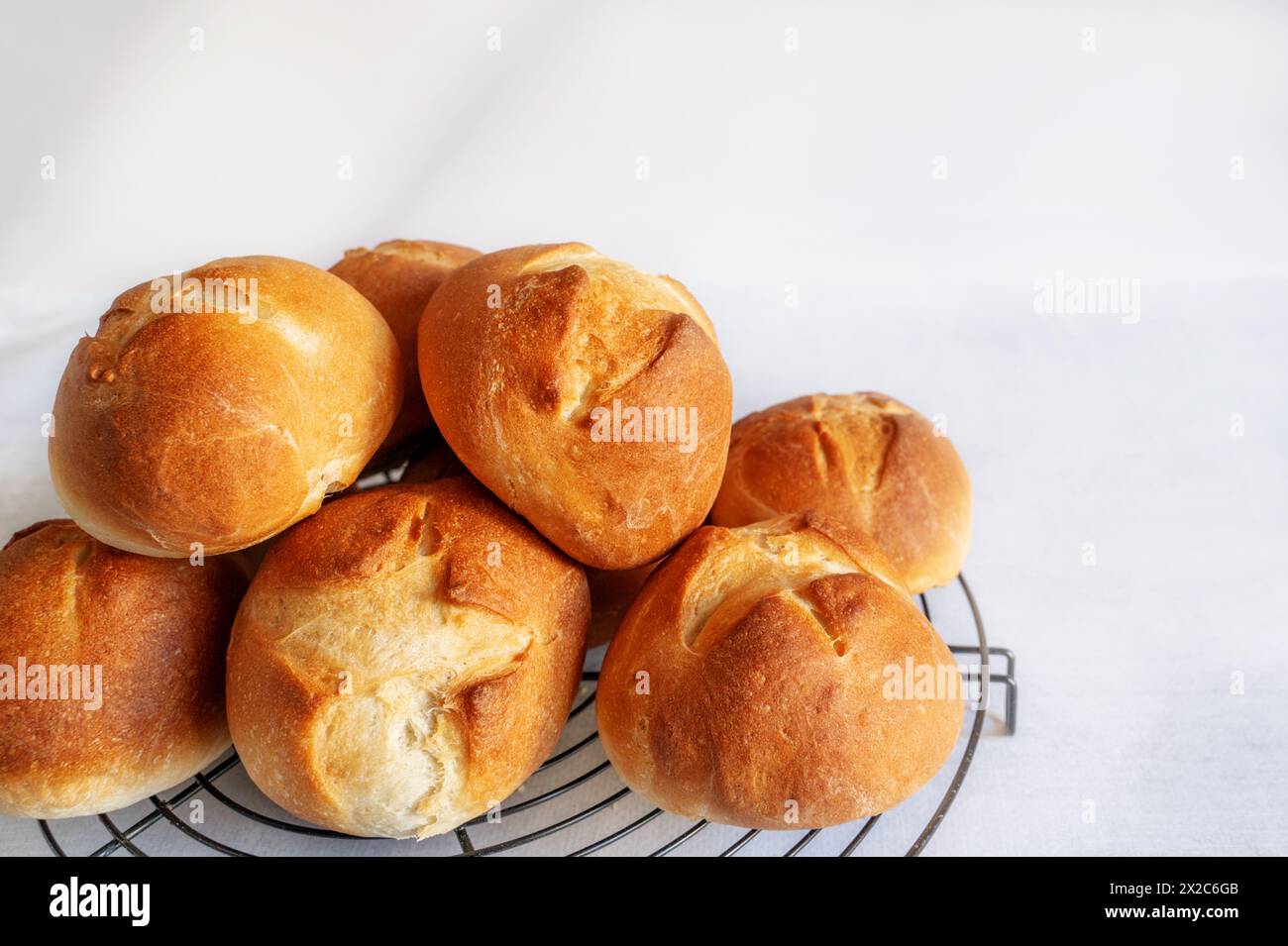 homemade buns. Homemade buns on wood board with wheat ears. Homemade Dinner Rolls, selective focus. Close-up. Copy space Stock Photo