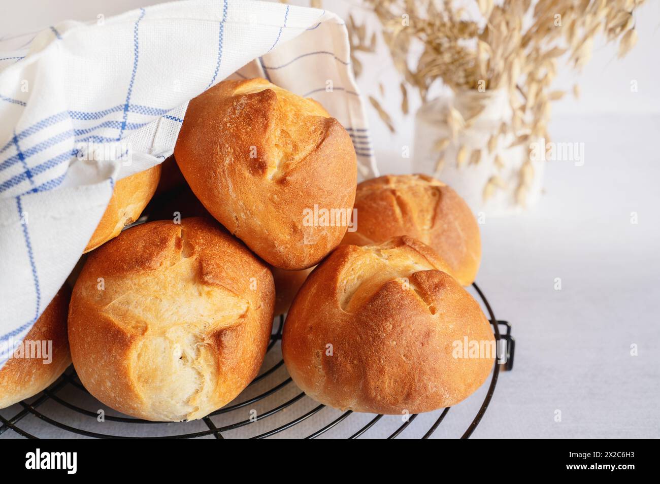 homemade buns. Homemade buns on wood board with wheat ears. Homemade Dinner Rolls, selective focus. Stock Photo