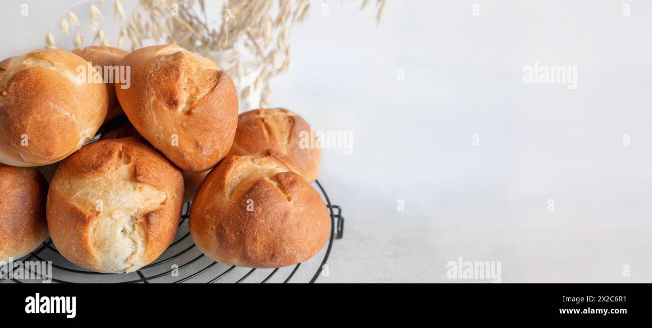 homemade buns. Homemade buns on a wooden board with wheat ears. Homemade buns for dinner, boiled with vegetable milk. Copy space. banner Stock Photo