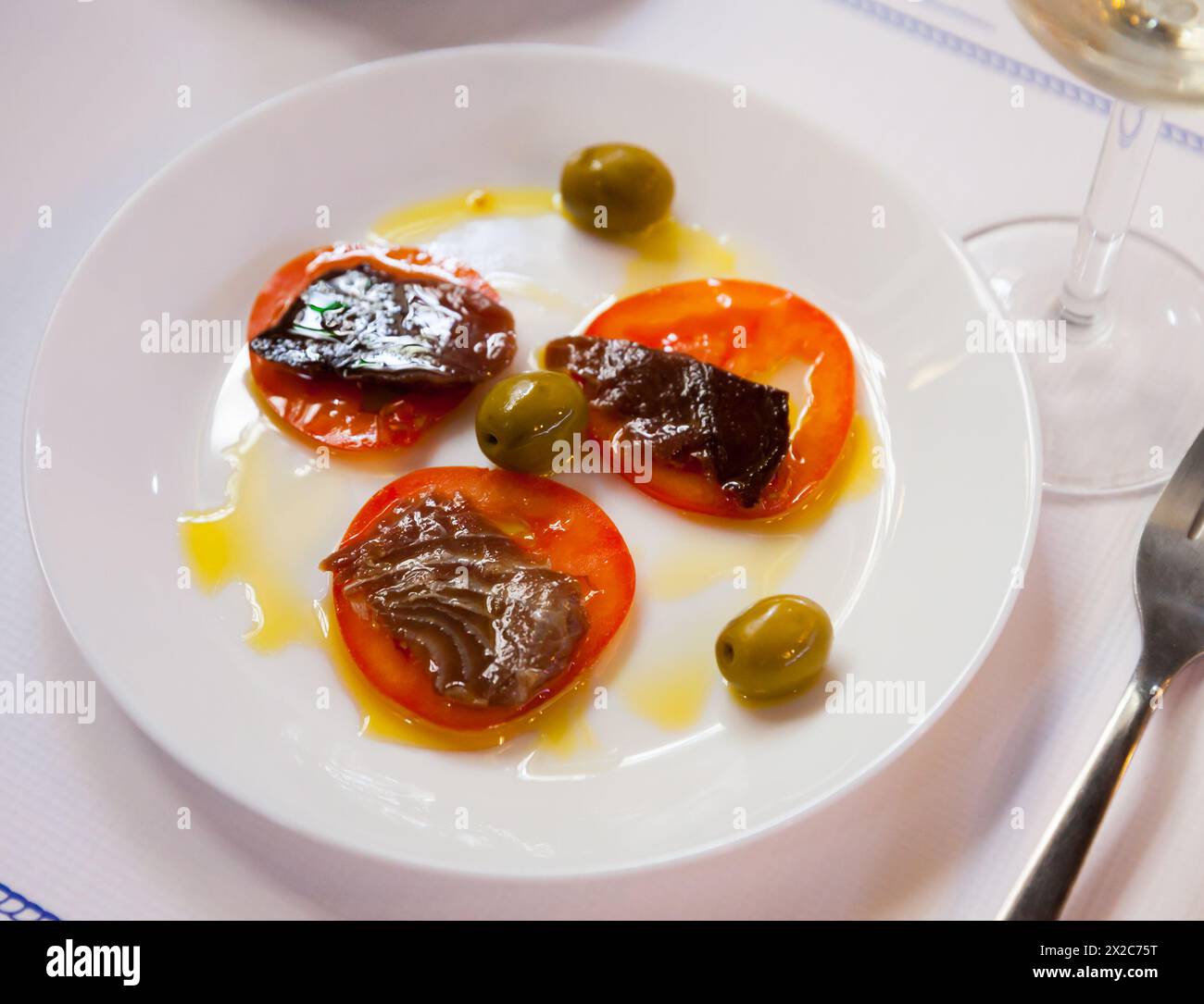 Sarda fish on tomato slices Stock Photo
