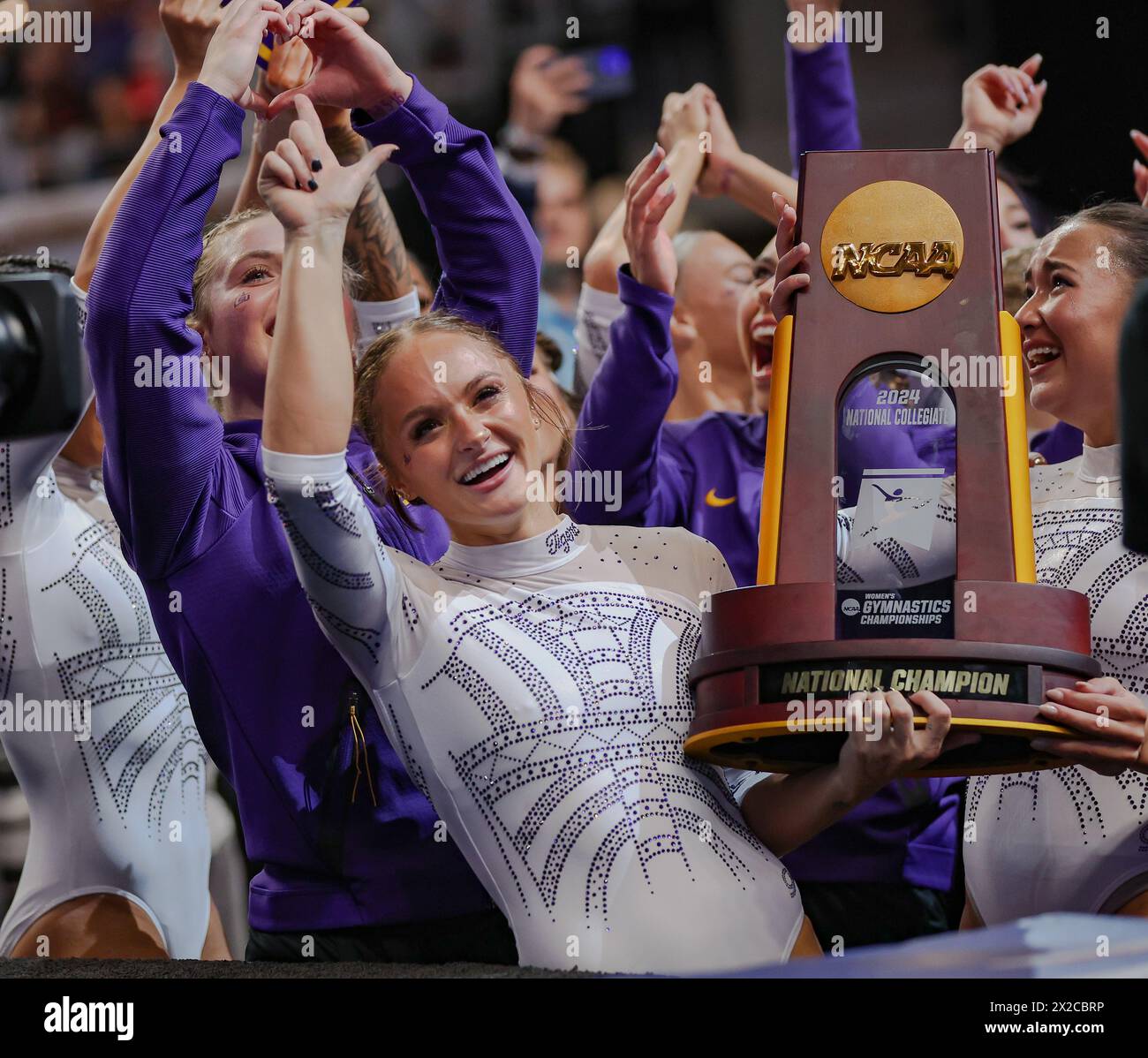 Fort Worth, TX, USA. 20th Apr, 2024. LSU's Savannah Schoenherr shows the championship trophy to the Tiger fans the 2024 NCAA Women's Gymnastics Championships at Dickies Arena in Fort Worth, TX. Kyle Okita/CSM/Alamy Live News Stock Photo