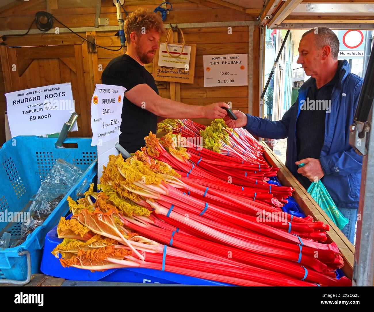 At Wakefield city centre, buying E Oldroyd rhubarb in February on the market, West Yorkshire, England, UK, WF1 3AE Stock Photo