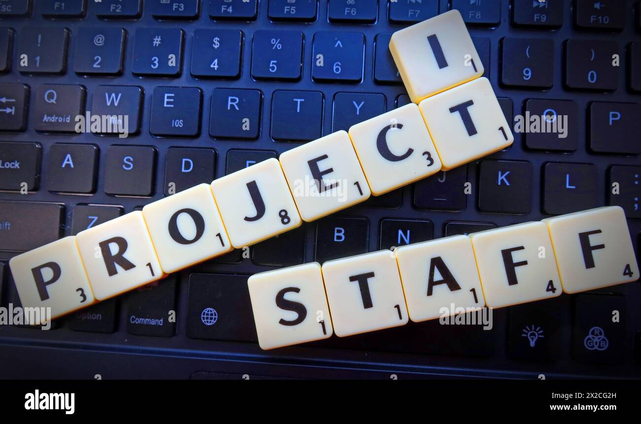 IT Project Staff, in Scrabble letters & words on a computer keyboard Stock Photo