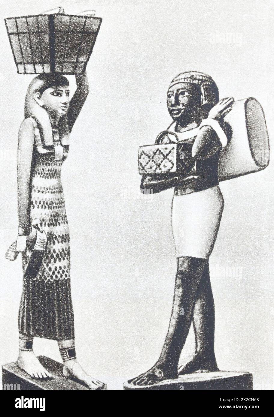 Ancient Egyptian wooden figurines depicting servants from a rich house of the 3rd millennium BC. Photo from the mid-20th century. Stock Photo