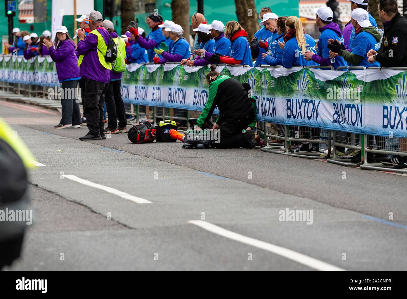 London, UK. 21st Apr, 2024. Milkesa Mengesha collapses at 39 km marker, and is helped by volunteers and staff for St John's ambulance, Milkesa Mengesha of Ethiopia competes in the Men's elite race during the 2024 TCS London Marathon on April 21st  England Credit: Vue Studios/Alamy Live News Stock Photo