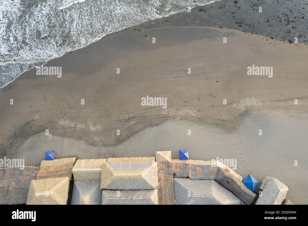 Bungalow roof next to beach aerial drone top view Stock Photo