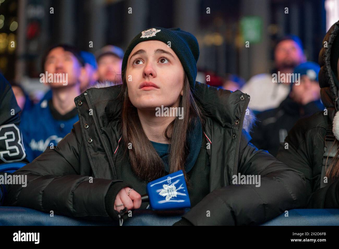Fans watching the game on a giant screen react as the Boston Bruins score a goal against the Toronto Maple Leafs at Maple Leaf Square outside Scotiabank Arena. During Toronto Maple Leafs playoff games, Maple Leaf Square transforms into a sea of blue and white, echoing with the chants of passionate fans eagerly rallying behind their team's quest for victory. The electric atmosphere radiates anticipation and excitement, creating unforgettable memories for both die-hard supporters and casual observers alike. (Photo by Shawn Goldberg/SOPA Images/Sipa USA) Stock Photo