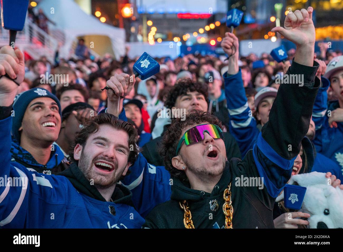 Fans watching the game on a giant screen react as the Toronto Maple Leafs score a goal against Boston Bruins, at Maple Leaf Square outside Scotiabank Arena. During Toronto Maple Leafs playoff games, Maple Leaf Square transforms into a sea of blue and white, echoing with the chants of passionate fans eagerly rallying behind their team's quest for victory. The electric atmosphere radiates anticipation and excitement, creating unforgettable memories for both die-hard supporters and casual observers alike. (Photo by Shawn Goldberg/SOPA Images/Sipa USA) Stock Photo