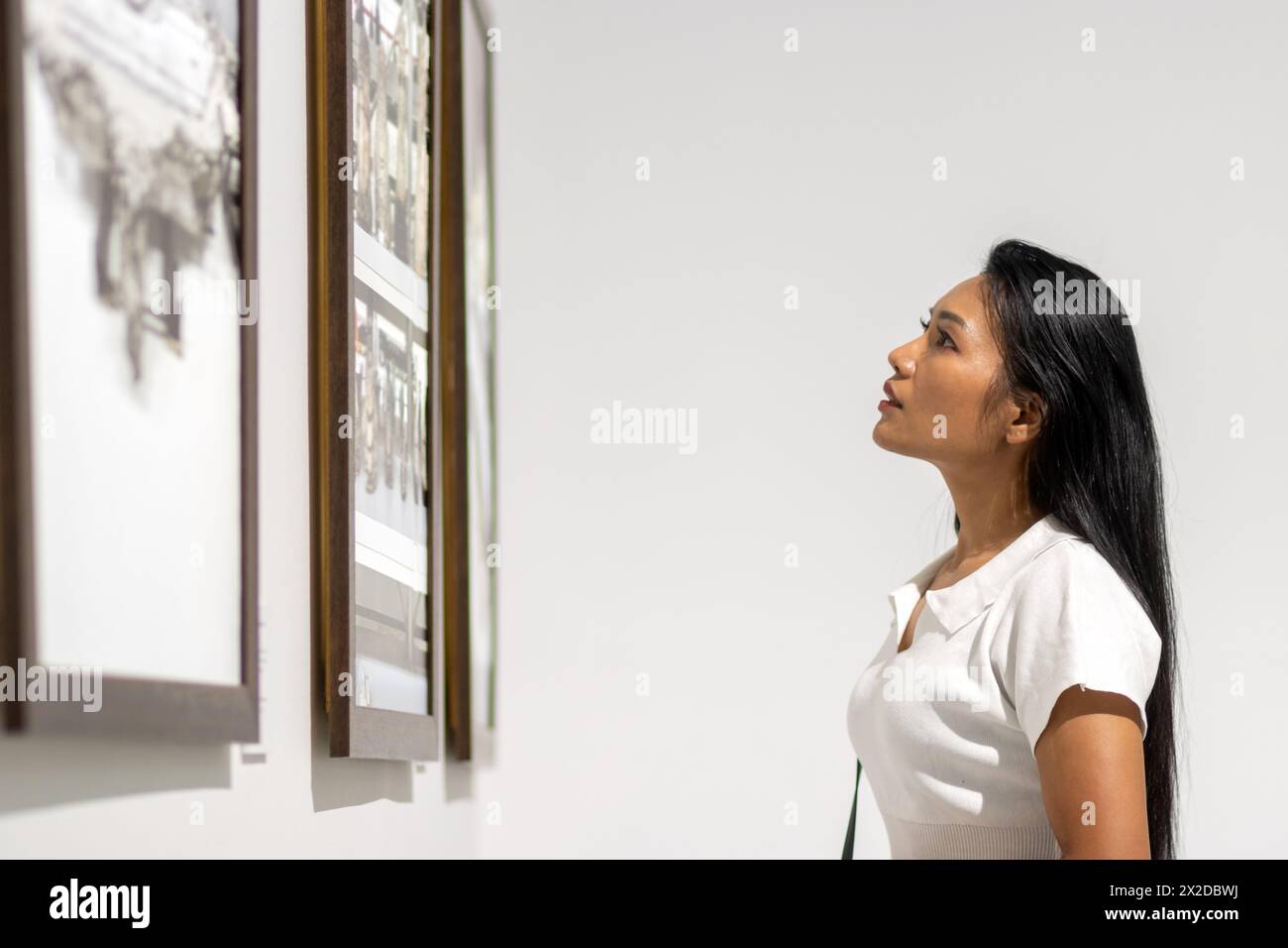 A young woman visited an exhibition of paintings and photographs Stock ...