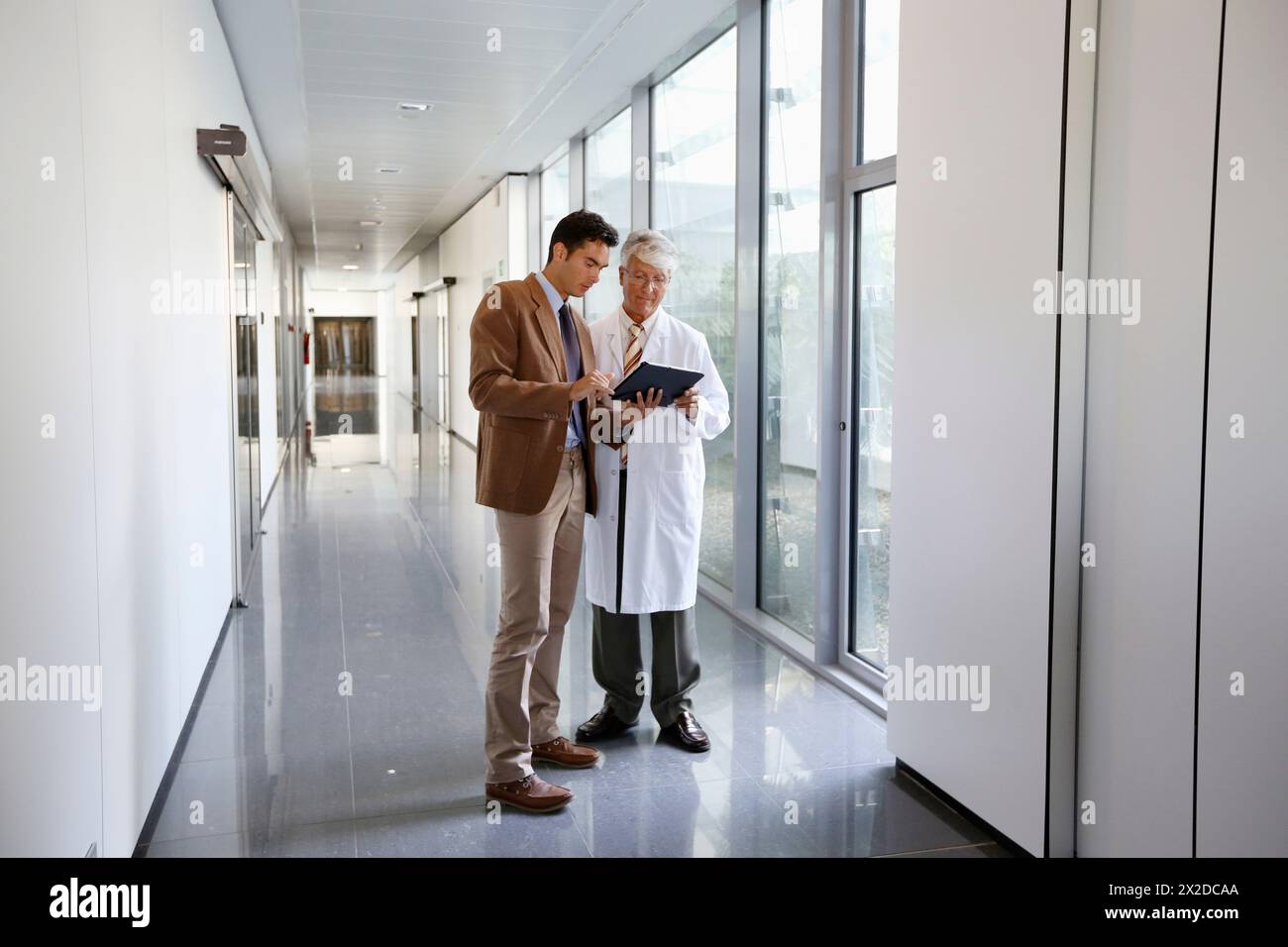 Doctor attending to seller, Corridor, Onkologikoa Hospital, Oncology Institute, Case Center for prevention, diagnosis and treatment of cancer, Donosti Stock Photo