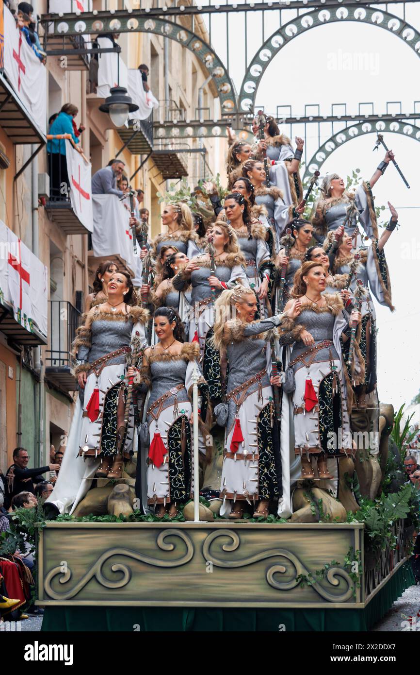 Alcoy, Spain, 04-20-2024: Favorite of the Christian Captain of the Alcodianos troupe on his float and court ladies in the Moors and Christians parade Stock Photo