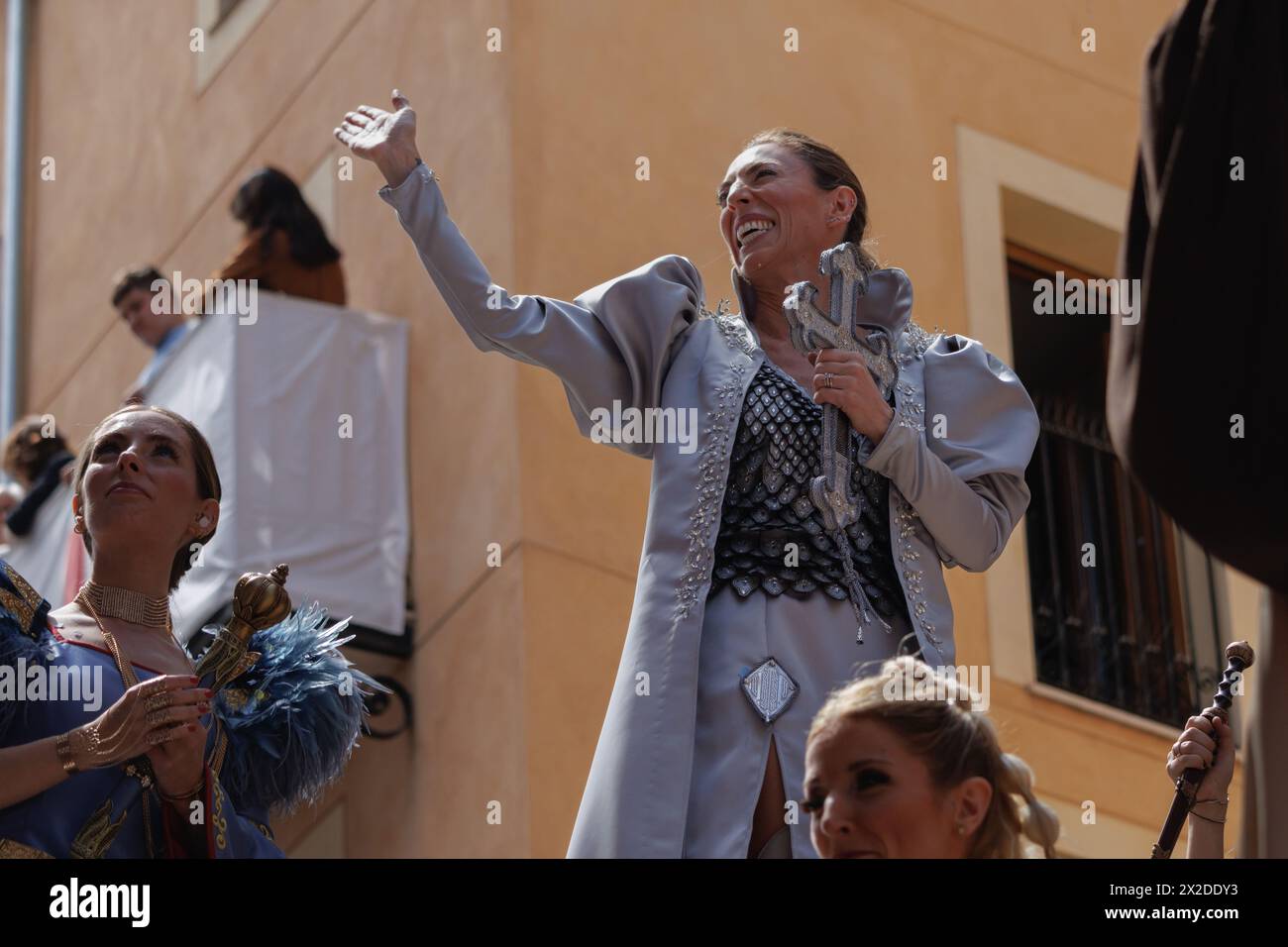 04-20-2024, Alcoy, Spain: Favorite woman of the ensign of the Aragoneses troupe smiling and waving during the Moors and Christians parade. Popular fes Stock Photo