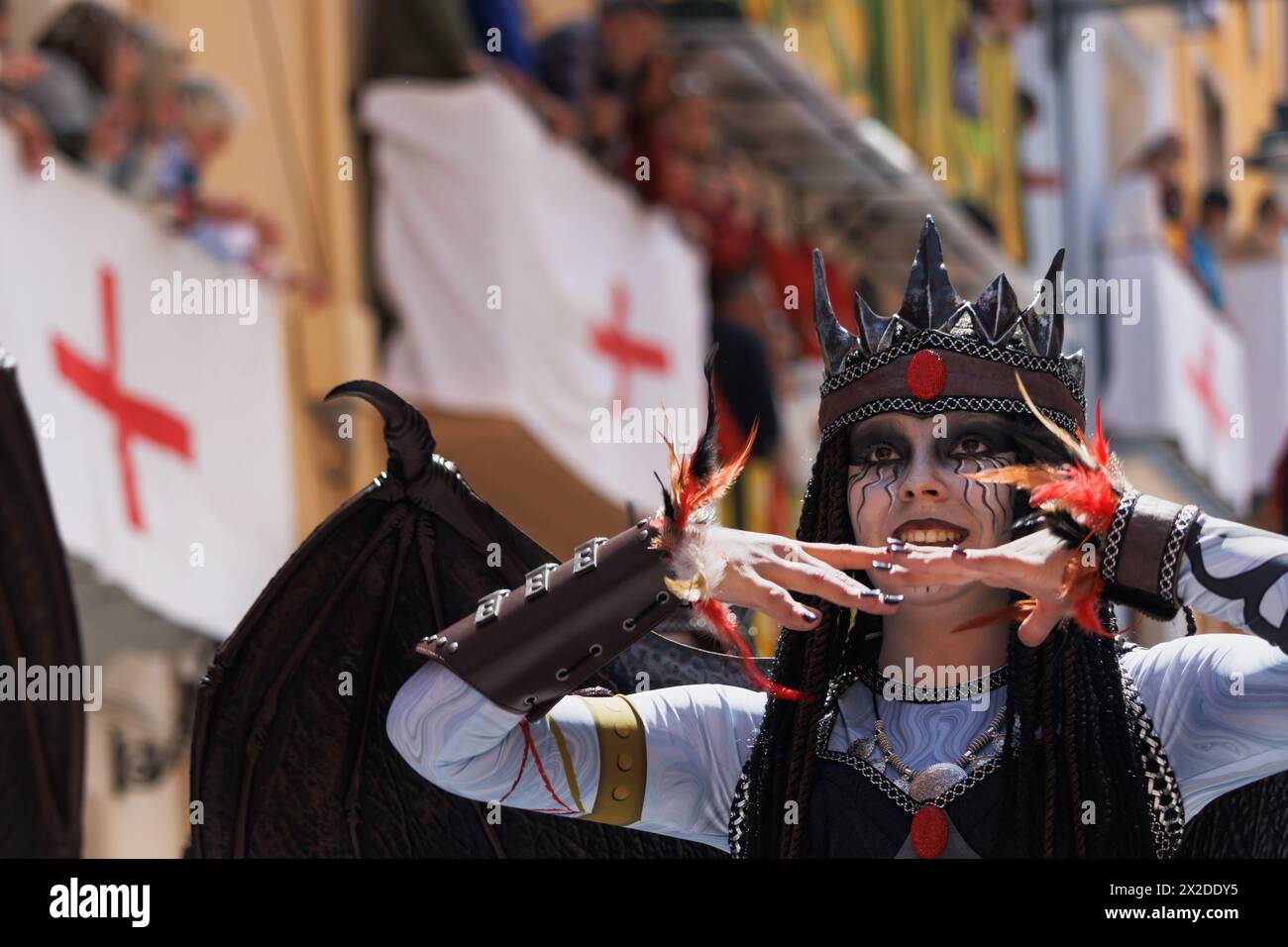 04-20-2024, Alcoy, Spain: Dancer with dragon wings and crown during her performance at the Alcoy Moors and Christians parade. Popular festivals declar Stock Photo