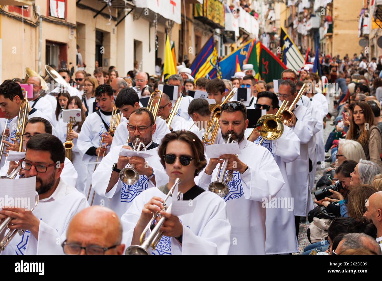 04-20-2024, Alcoy, Spain: Music band parading in tunics and enlivening the Moors and Christians festivals. Popular festivals declared of international Stock Photo