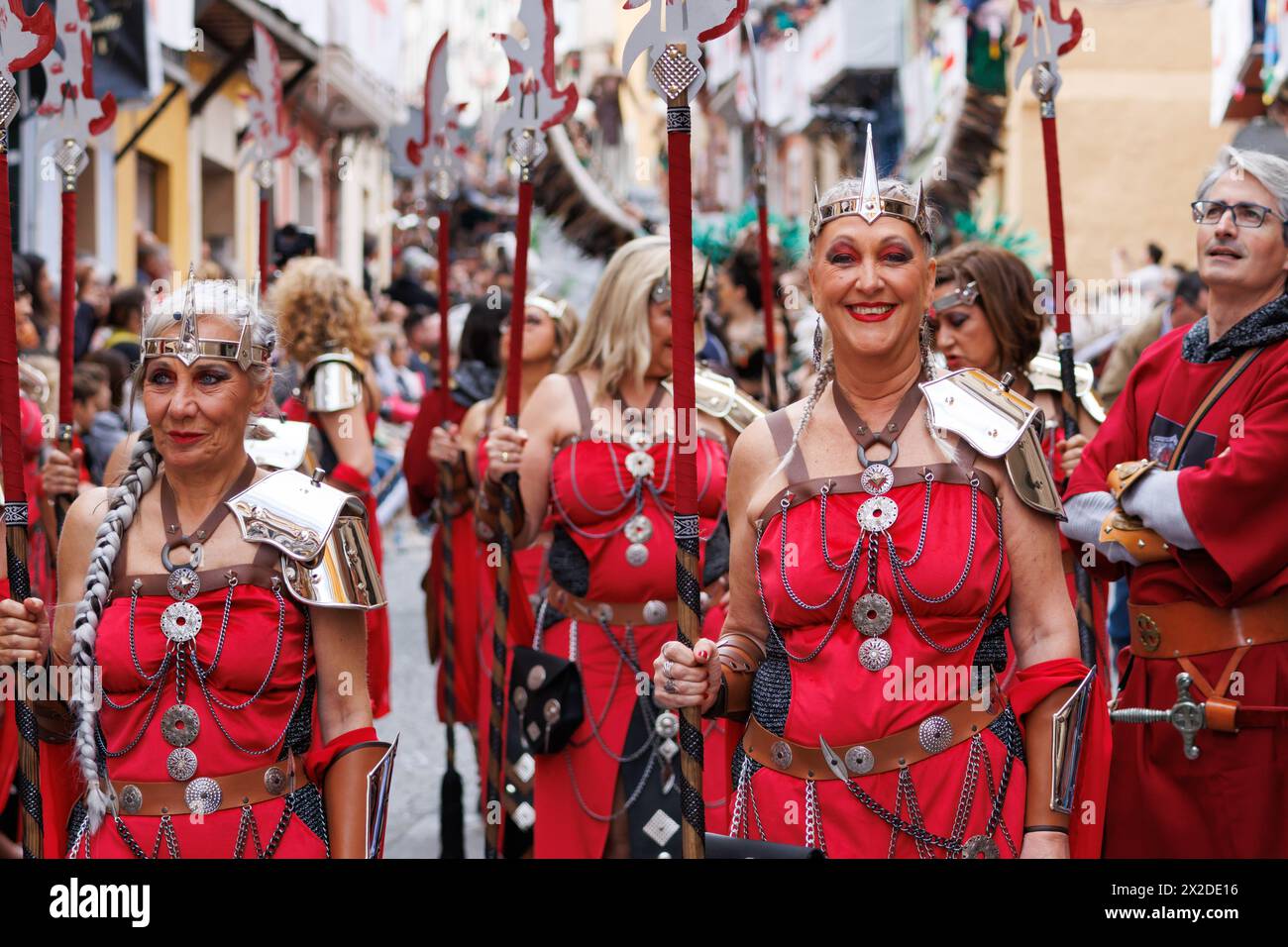 Alcoy, Spain, 04-20-2024: Women's war lance in the Moors and Christians parade accompanying the captain of the Alcodianos company Stock Photo
