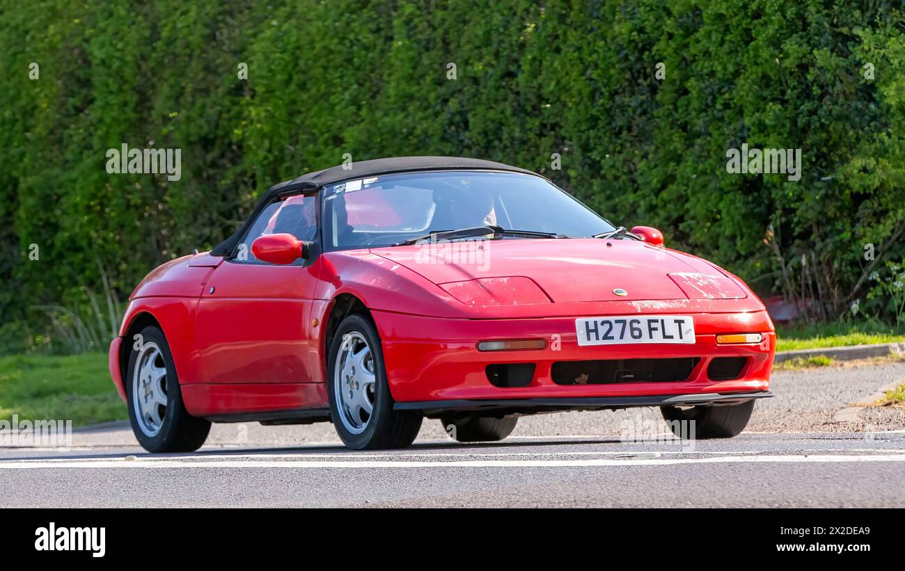 Bicester,UK- Apr 21st2024: 1990 red Lotus Elan classic car driving on a ...