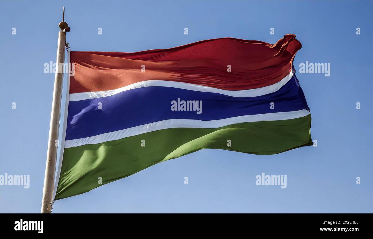 Die Fahne von Gambia, flattert im Wind, isoliert, gegen den blauen Himmel Stock Photo