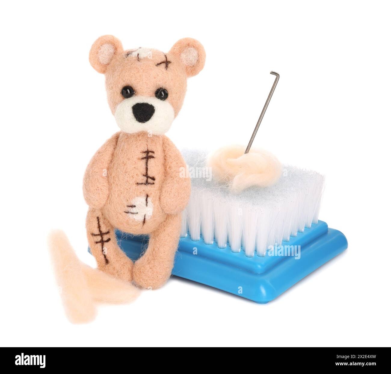 Needle felted bear, wool and tools isolated on white Stock Photo