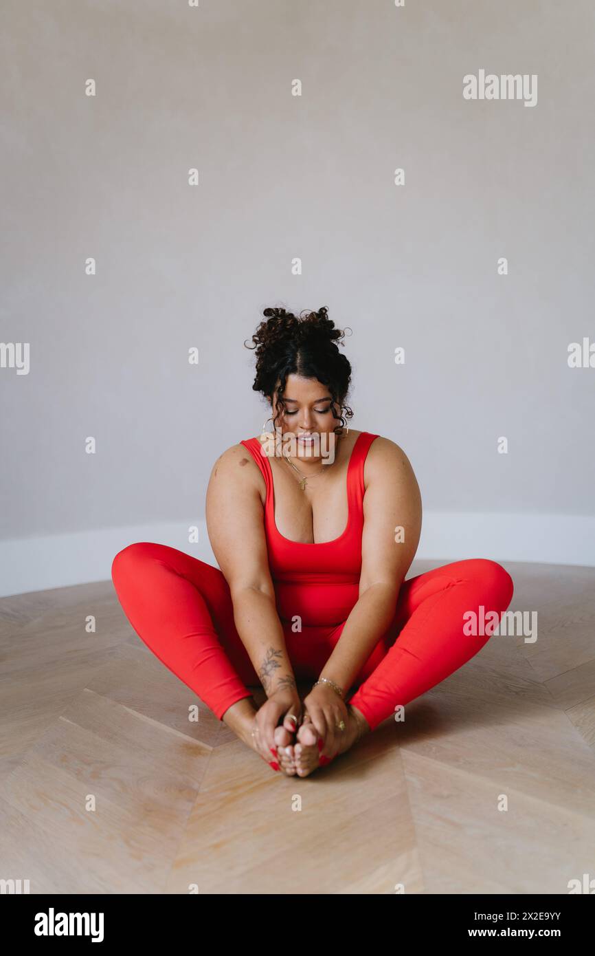 Woman in butterfly pose doing yoga Stock Photo