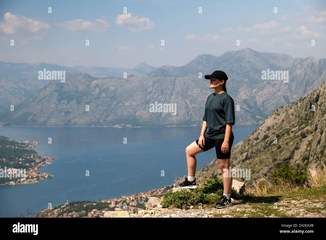 Woman Enjoying the Stunning View of Kotor Bay from Mountain Top Stock Photo