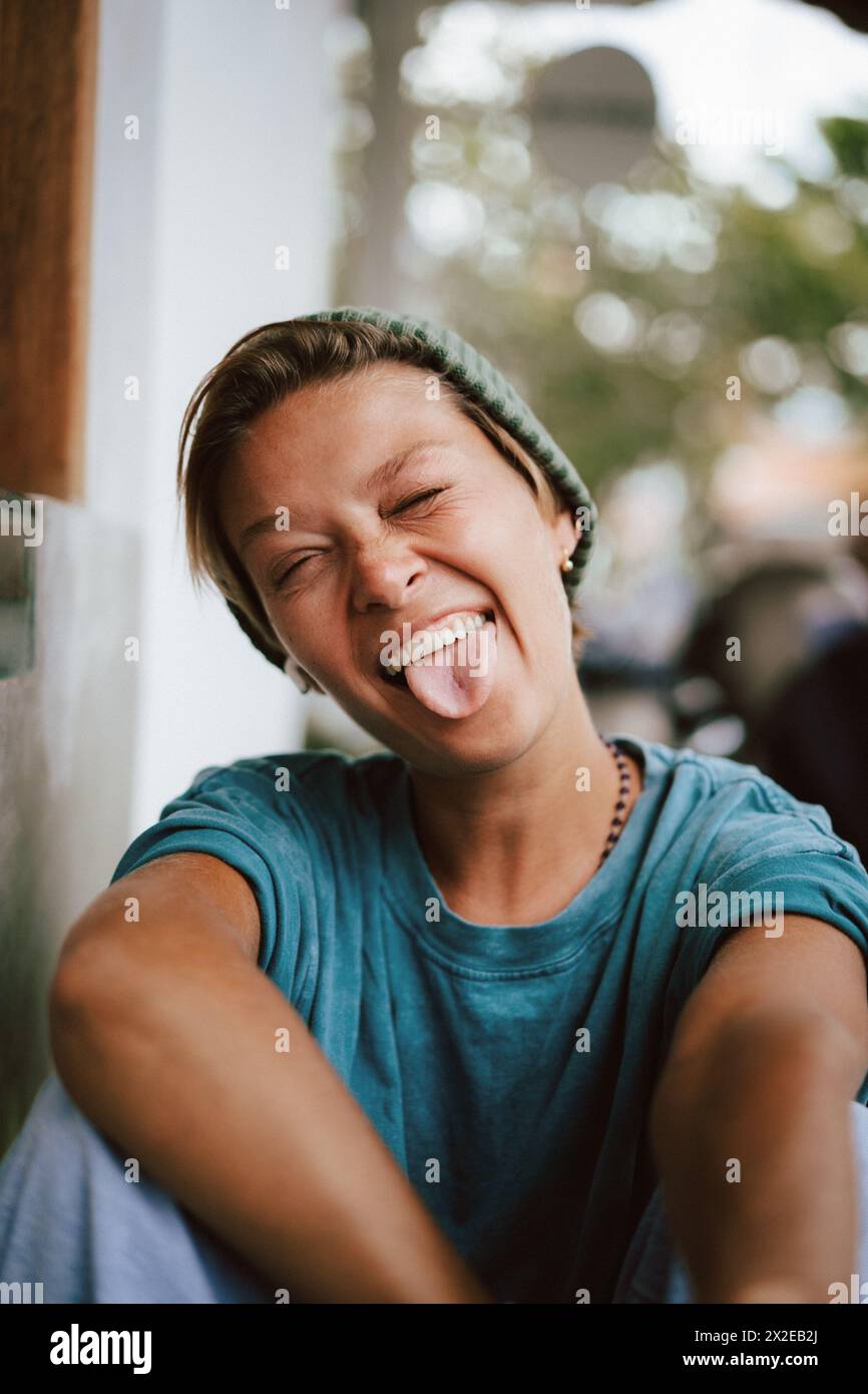 Close-up portrait of happy woman with  sticking out tongue Stock Photo