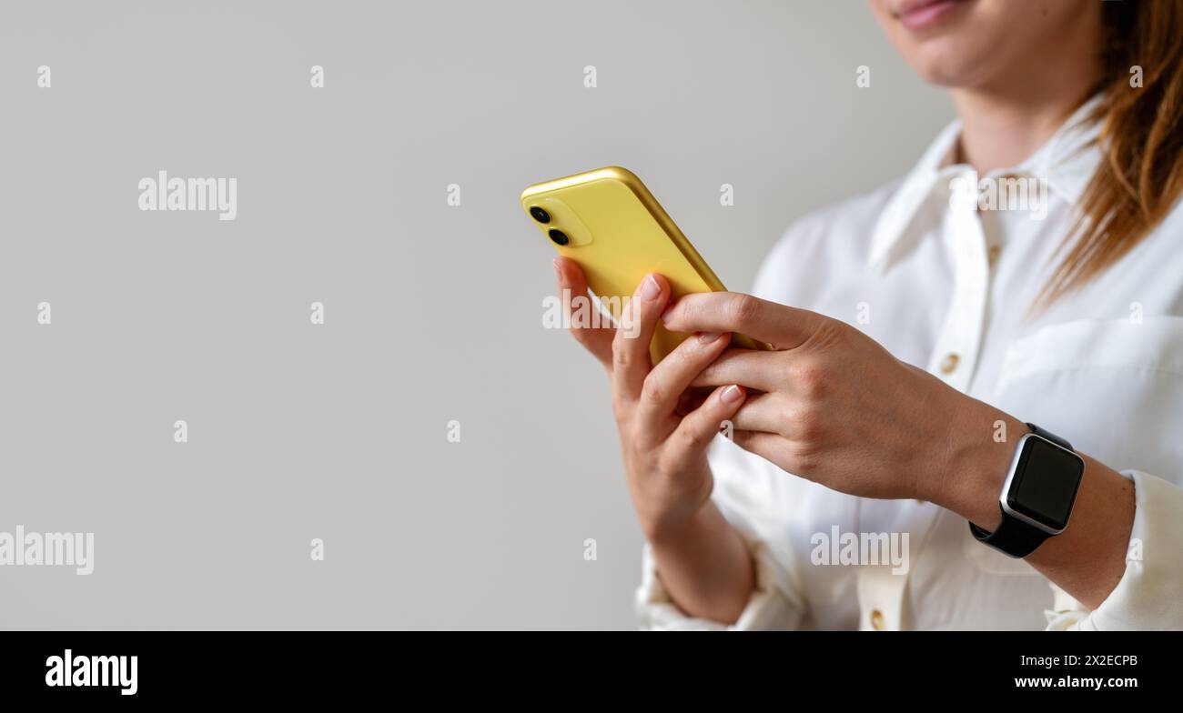 Looking for a job online using a mobile phone. Female businessperson woman exchanges messages online from a smartphone. Stock Photo