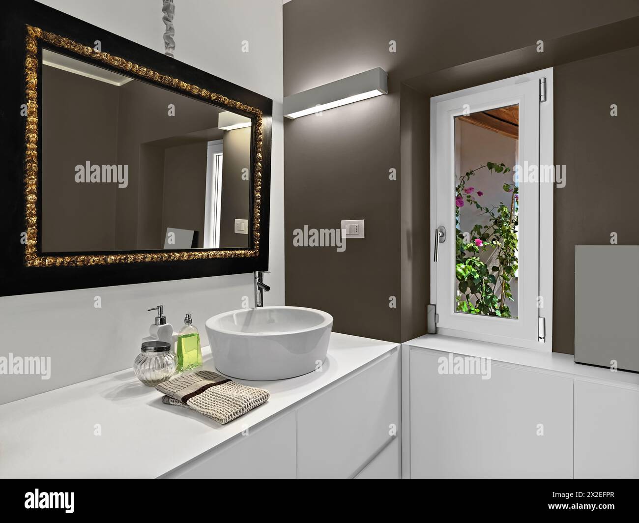 modern bathroom interior with large mirror above the bathroom sink Stock Photo
