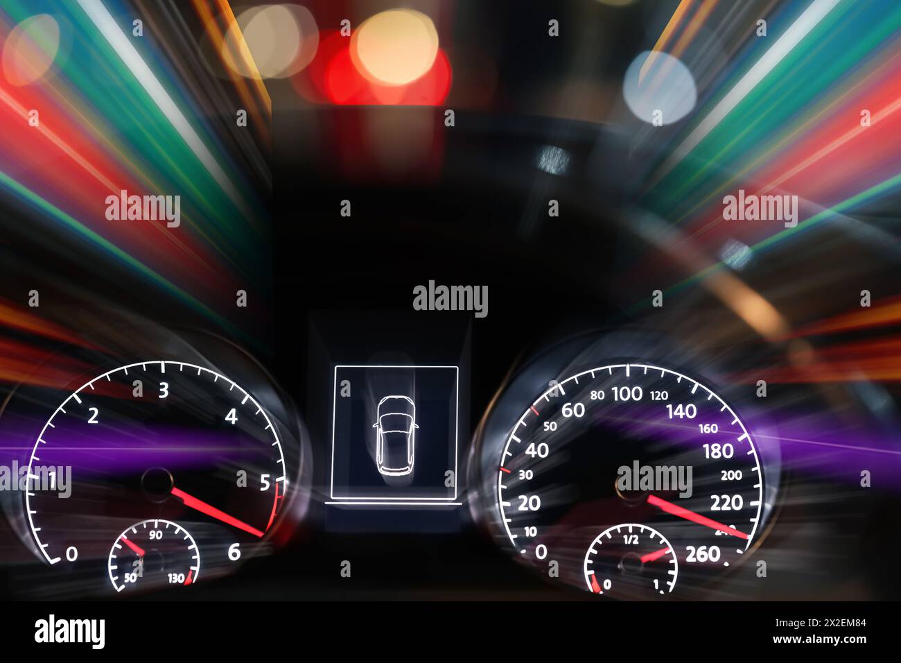 Speedometer and tachometer behind steering wheel in car, motion blur ...
