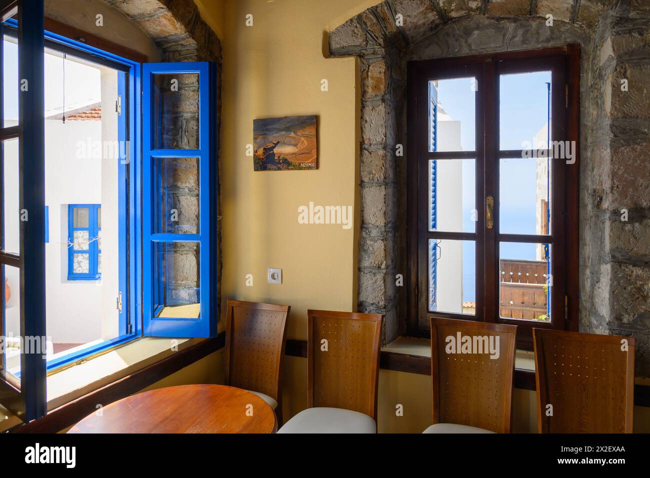Nisyros, Greece - May 10, 2023: The restaurant on central square of Nikia village. Nisyros island, Greece Stock Photo