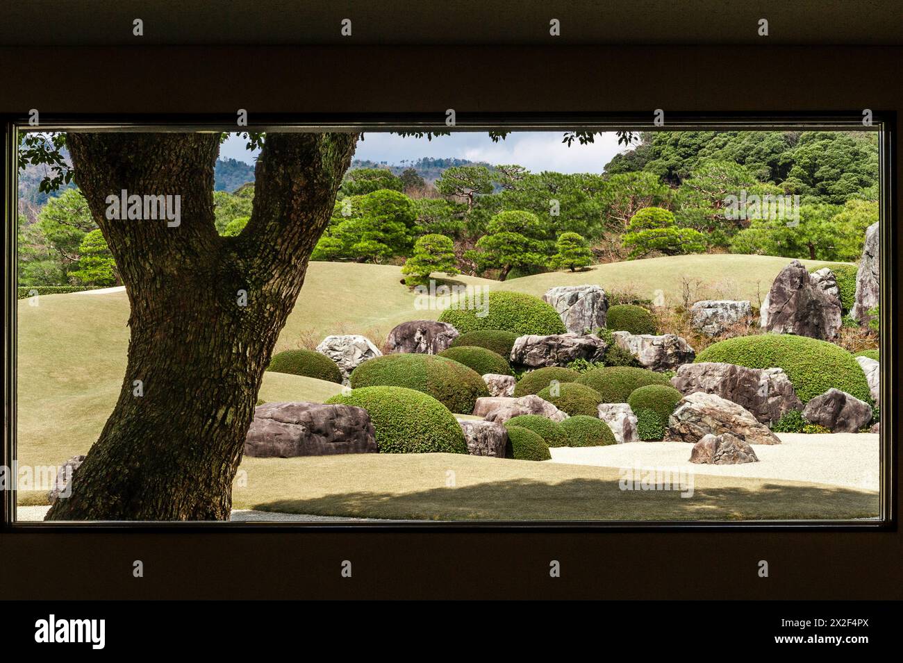 A window reveals a 'Living Framed Painting' in the famous gardens of