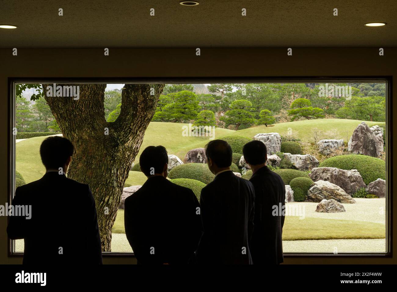 A window reveals a 'Living Framed Painting' in the famous gardens of