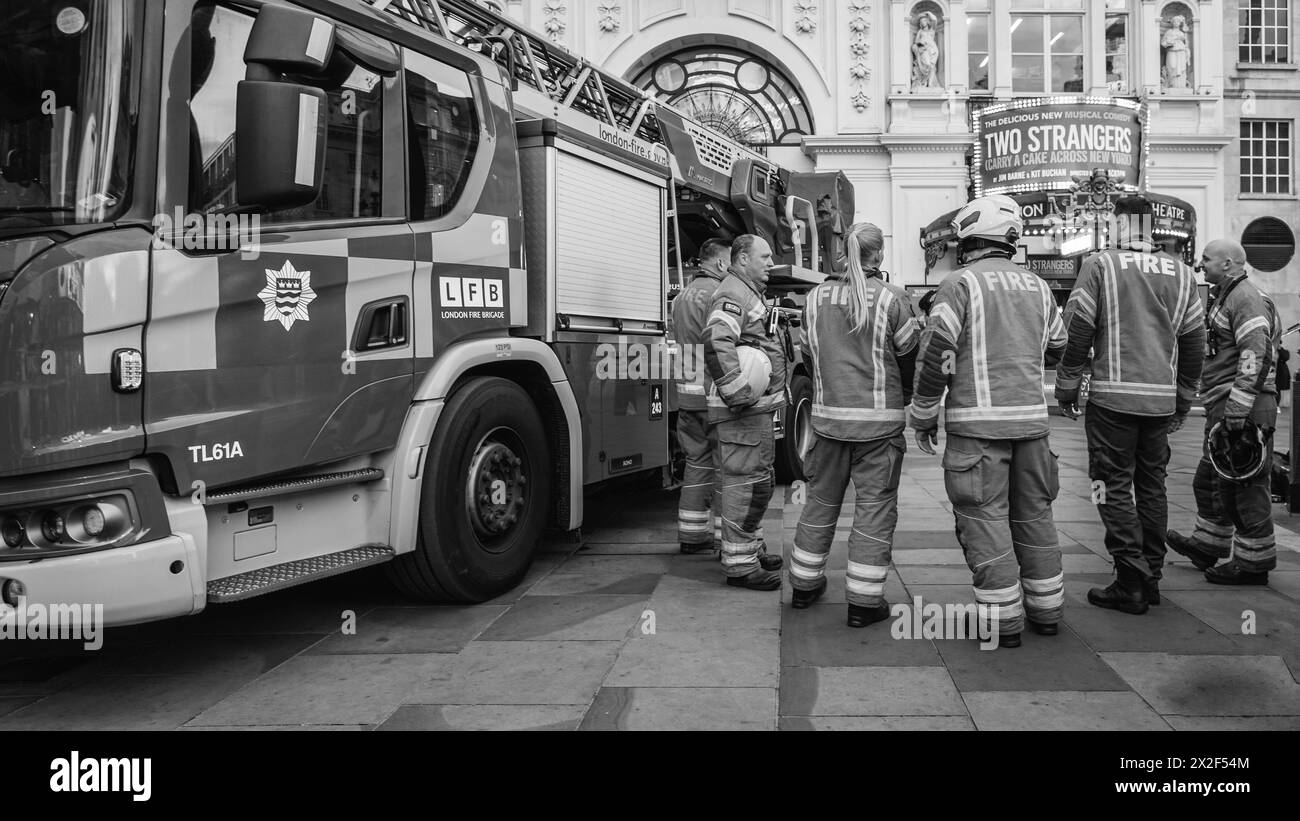 Black and white image of a team of firefighters at an incident in London's Piccadilly. Stock Photo