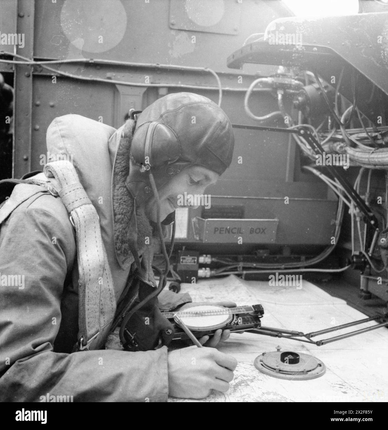 they-bombed-berlin-the-navigator-at-work-on-his-charts-in-the