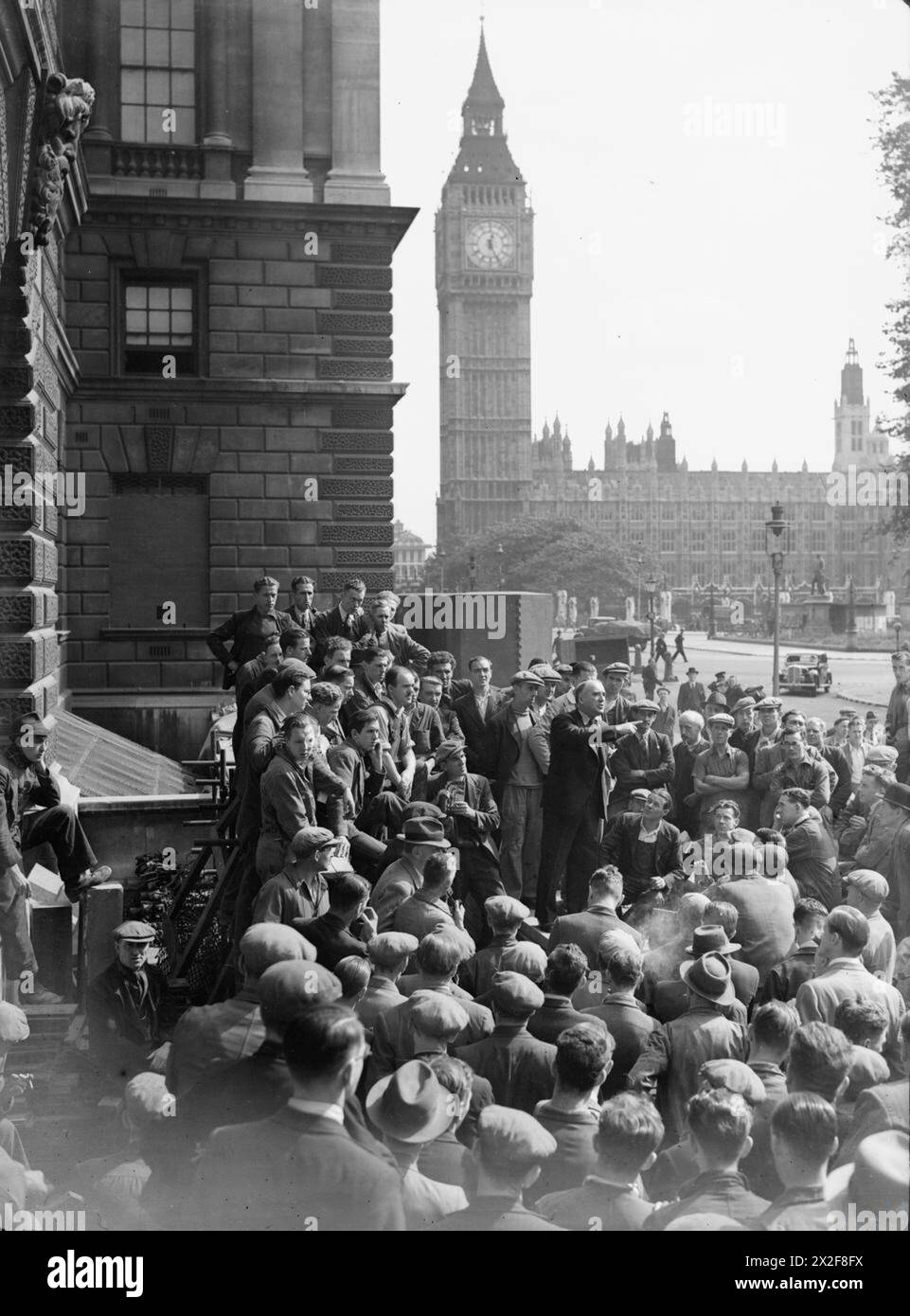 HARRY POLLITT SPEAKS AT WHITEHALL, LONDON, ENGLAND, 1941 - Harry Pollitt, General Secretary of the Communist Party of Great Britain, gives a speech to workers in Whitehall, London, 1941. Big Ben can be clearly seen behind him Pollitt, Harry Stock Photo