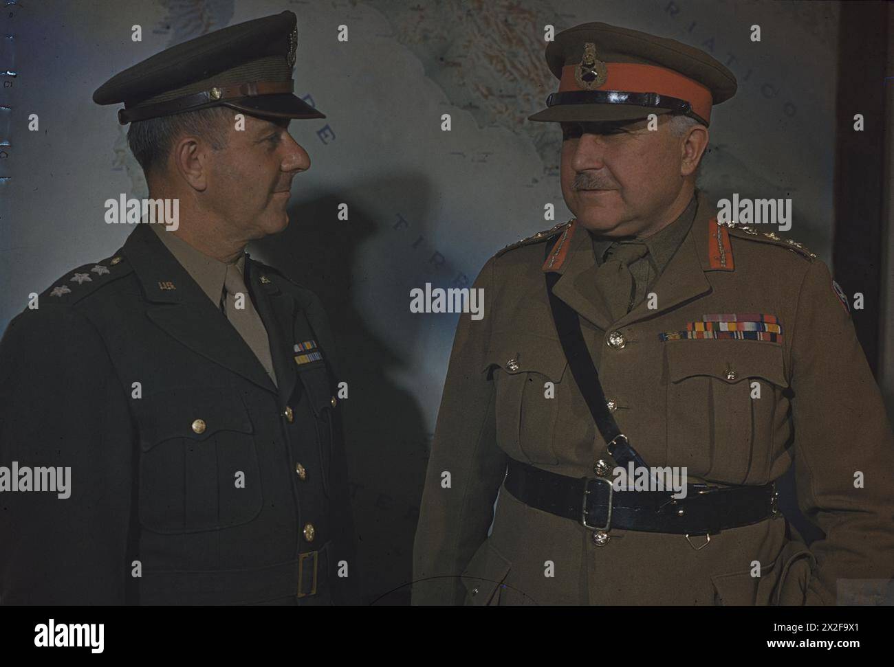 GENERAL SIR HENRY MAITLAND WILSON, THE SUPREME ALLIED COMMANDER, MEDITERRANEAN THEATRE, IN ITALY, 30 APRIL 1944 - General Sir Henry Maitland Wilson, Supreme Allied Commander, Mediterranean Theatre, and the Deputy Commander in Chief, Mediterranean Theatre, Lieutenant General J L Devers, standing in front of a map at the main headquarters of the Fifth Army Wilson, Henry Maitland, Devers, Jacob Loucks, British Army Stock Photo