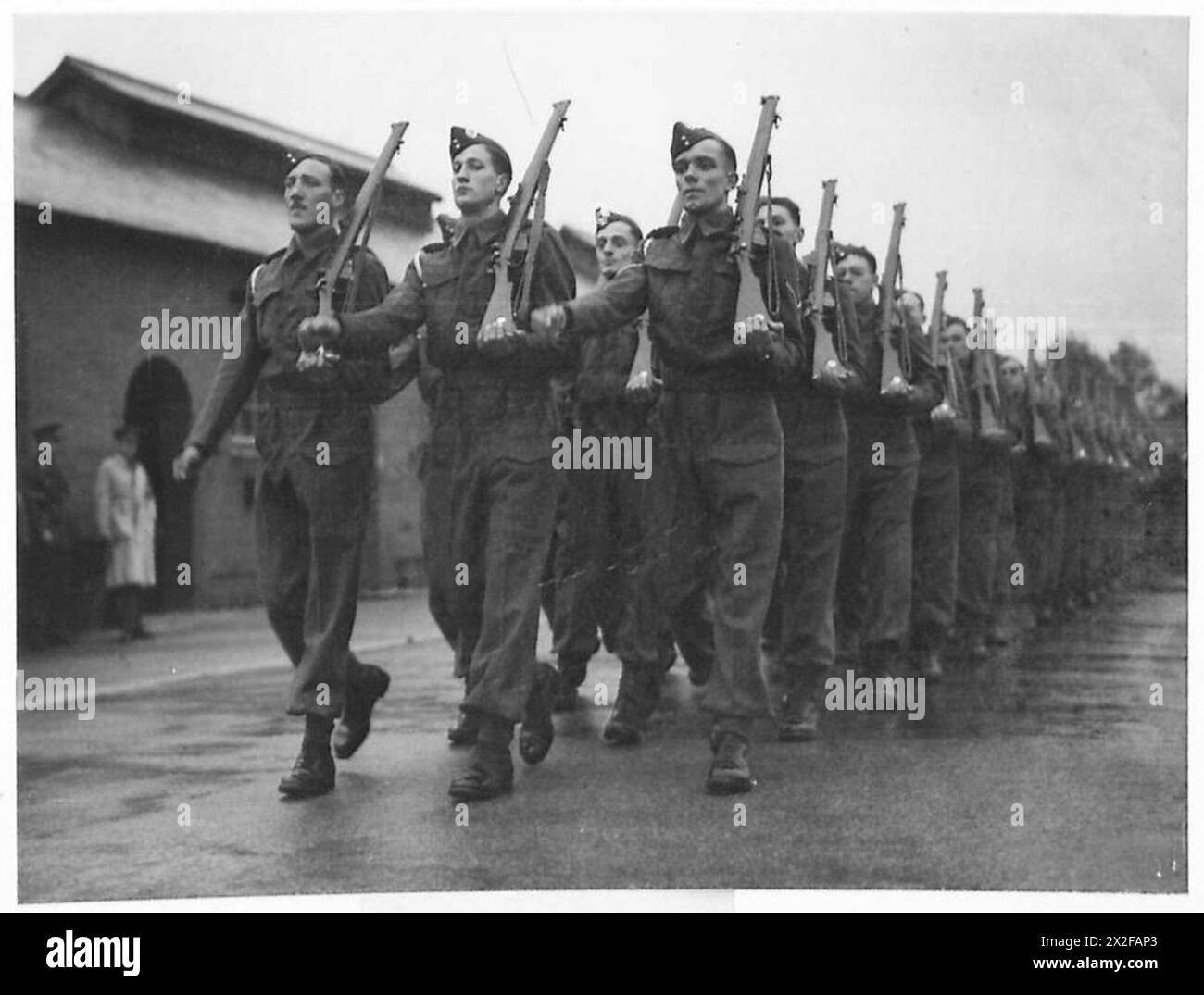 FROM "CIVVIE" TO SOLDIER Now a L/Corporal, Langley is seen (on right