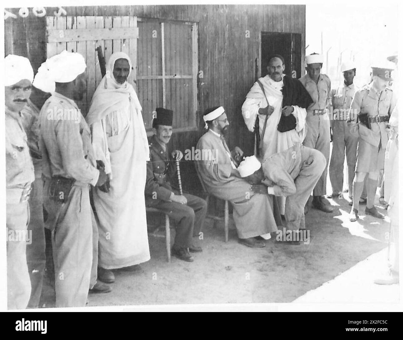 A visit to an Italian prisoner of war camp shows a prisoner interacting ...