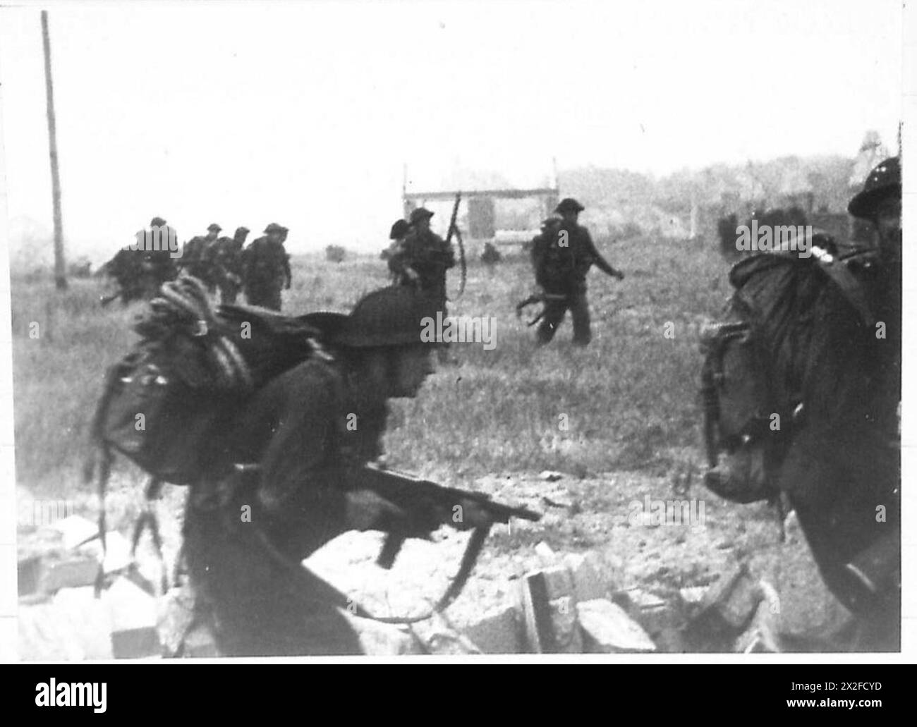 Commandos of No. 4 Commando, 1st Special Service Brigade, move inland ...