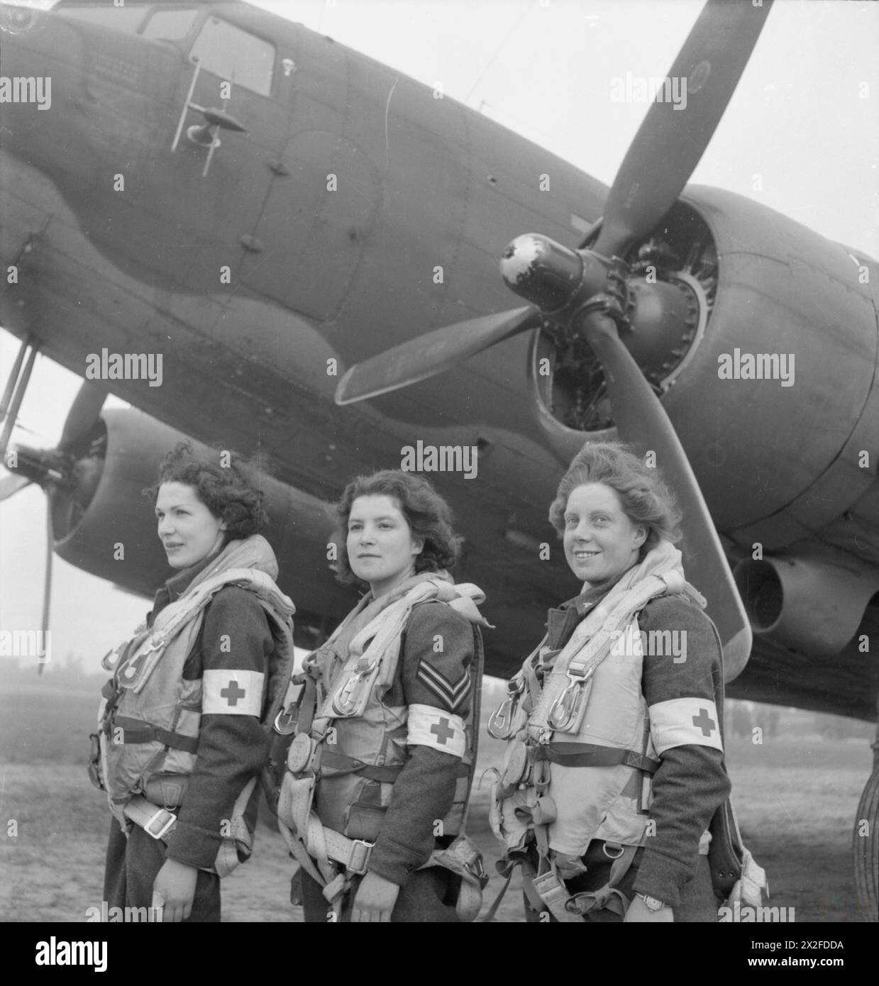 ROYAL AIR FORCE TRANSPORT COMMAND, 1943-1945. - The first WAAF nursing orderlies selected to fly on air-ambulance duties to France, standing in front of a Douglas Dakota Mark III of No. 233 Squadron RAF at B2/Bazenville, Normandy. From left to right: Leading Aircraftwoman Myra Roberts of Oswestry, Corporal Lydia Alford of Eastleigh and Leading Aircraftwoman Edna Birbeck of Wellingborough Royal Air Force, Maintenance Unit, 235, Royal Air Force, Women's Auxiliary Air Force Stock Photo